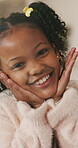 Smile, hands and face of child in home for youth, wellness and weekend break in lounge. Happiness, positive attitude and relax with portrait of girl in living room of apartment for peace and calm