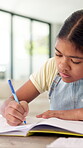 Education, child and writing on paper in home for math homework, calculation solution or study. Student, kid or numeracy worksheet in house for problem solving, division answer or learning assessment