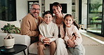 Happy, hug and face of parents with children on sofa in home for bonding, connection or family. Smile, relax and portrait of kids embracing mom and dad in living room at apartment for weekend.