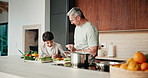 Cooking, learning and dad with child with food for meal prep, lunch and recipe in kitchen. Family, teaching and father with boy cutting vegetables for healthy diet, nutrition and bonding in home