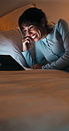 Laugh, dark and woman on tablet in bed for online streaming, comedy movie and internet. Night, home and happy person on digital tech for subscription, connection and funny video for humor in bedroom