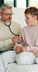 Doctor, sick child and breathing in home with stethoscope, consultation or healthcare with parent. Lung wellness, medical pediatrician and visit boy for illness diagnosis or help with mom on bed