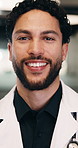 Face, man and doctor with smile for healthcare, pride and career ambition in hallway. Confidence, physician or medical professional with portrait for about us, management and support in hospital