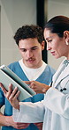 Doctor, healthcare and tablet with nurse in hospital for feedback, internship or training. App, collaboration and conversation with medical woman talking to resident for learning, teaching or update
