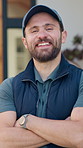 Face, delivery and happy man with confidence for courier service or freight safety in home. Portrait, male person or carrier with smile or arms crossed for distribution, logistics or transportation