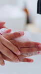 Mother, child and washing hands in bathroom with foam, assistance and teaching hygiene for wellness. Mom, kid and cleaning skin in home with soap, bacteria prevention and learning healthy habits.
