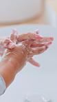 Child, foam and washing hands in bathroom with wellness, bacteria prevention and protection from germs. Kid, cleaning fingers and dirt removal in home with soap, learning healthy habits and hygiene.