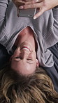 Above, laughing and phone with woman in home for reaction to meme or online joke. App, social media and typing text message with funny person in apartment, relax or upside down for break and humor