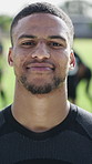 Face, athlete and man at stadium for fitness, training and confident for rugby tournament. Portrait, male person and player at field for contest, match practice and positive attitude for competition