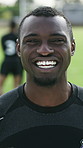 Face, smile and man on soccer field for exercise, training and match practice for tournament. Portrait, athlete or player with male person for football, sports challenge and confident for competition