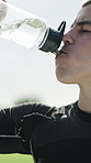 Athlete, drinking water and break on sports field for training, workout and exercise outdoors. Fitness, rest and male football player with h2o liquid, bottle and hydration for tournament practice
