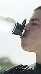 Athlete, drinking water and break on sports field for fitness, workout and exercise outdoors. Training, rest and male soccer player with h2o liquid, bottle and hydration for tournament practice