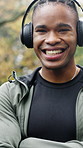 Headphones, face and black man with arms crossed for fitness, morning cardio and music playlist. Relax, athlete and happy outdoor for wellness practice, health confidence and streaming audio album
