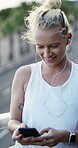 Fitness, phone and woman with earphones in city, connection and listening to music with subscription. Happy, athlete and person with chat on mobile, wellness and streaming audio with tech on bridge