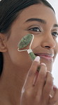 Woman, smile and jade roller in bathroom for skincare, lymphatic drainage and massage in home. Cosmetics, facial treatment and gua sha with stone tool for beauty, anti aging and blood circulation
