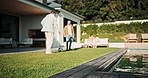 Soccer, ball and father with child in backyard by home for practice, bonding or sports game. Kicking, football and dad with boy kid outdoor for training, connection or match together by house.