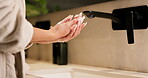 Sink, soap, washing hands with woman in bathroom of home for disinfection or hygiene. Basin, cleaning and skincare with person in apartment to remove bacteria or germs for morning self care routine