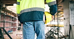 Construction, hardhat or person on site with inspection, safety check or evaluation in building project. Back, ppe or engineer with walk, progress track or quality assurance in industrial compliance.