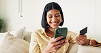Phone, credit card and woman on sofa in home with online shopping, ecommerce or purchase on mobile app. Laugh, debit and female person with cellphone for order on website in living room at apartment.