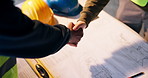 Handshake, blueprint and construction workers on site with agreement, partnership or maintenance deal. Floor plan, people and contractor shaking hands with civil engineer for building approval.
