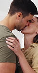 Couple, hug and kiss in kitchen with smile for cooking, support and bonding together with meal prep. Man, woman and happy in home with conversation for lunch, love and commitment in healthy marriage