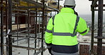 Man, architect and phone call at scaffolding for planning, compliance update and renovation. Engineer, back of person and tech on construction site for project feedback, talk and explaining extension