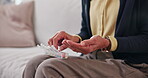 Retirement, sorting or hands in house with pillbox, treatment plan or dosage in wellness. Medication, medical or old person with container, prescription organizer or drug routine in health management