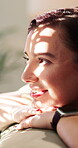 Happy, sunlight and woman on sofa for thinking, reflection and memory for good mood on weekend. Smile, home and person with inspiration, thoughtful and wondering for positive mindset, peace and relax