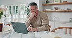 Online, stress and man with laptop in kitchen, freelancer or accountant with report for tax deadline. Remote work, worry and mature person with tech, thinking and audit review with paperwork in house