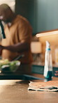 People, hands or cleaning table in kitchen for food hygiene, meal prep or disinfection in home. Couple, cooking or wiping surface with cloth or detergent for health, wellness or germ removal in house