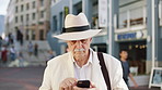 Phone, travel and senior man in city with texting, networking or contact on mobile app on holiday. Technology, retirement and elderly person on cellphone for communication in urban town on vacation.