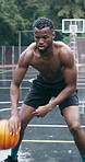 Basketball, dribble and black man on court with skill for outdoor practice, exercise or training. Male person, active sport or African player bouncing ball on wet pitch for game, match or control