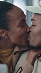 Kiss, funny and black couple in coffee shop, celebration for anniversary and relationship.  Relax, African man and woman in cafe, holiday and bonding together for commitment, laughing or happiness