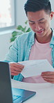 Man, laptop and office with letter for payslip, salary cheque or payment notice in workplace. Happy, male person or employee working with smile, note or document on computer for statement or earnings