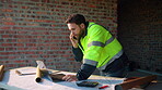 Man, laptop and phone call on construction site for planning, material order or schedule update. Engineer, tech and talking for urban development with compliance feedback, blueprint review or contact