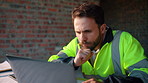 Reading, thinking or man with laptop at construction site, engineering or property development idea. Smile, infrastructure reflection or contractor with renovation planning, building insight or pc