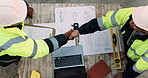 Blueprint, laptop and construction managers with handshake on site for industrial partnership. Floor plan, men and civil engineers shaking hands for agreement on building with computer from above.