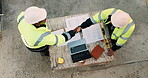 Blueprint, laptop and construction workers with handshake on site for industrial partnership. Floor plan, men and civil engineers shaking hands for agreement on building with computer from above.