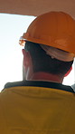 Man, architect and vision with helmet on construction site for building development or improvement. Back view, male person or civil engineer with hard hat, lens flare or ambition for contract in city