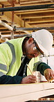 Construction, measure and man with wood at site for accuracy, renovation and building project. Architecture, contractor and person with measuring tape for dimensions, distance and infrastructure
