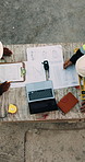 Blueprint, men and construction workers with laptop on site for planning home renovation from above. Floor plan, computer and male civil engineers in discussion for repairs, maintenance or building.