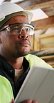 Thinking, black man and construction worker on site with tablet for email with feedback on building approval. Digital technology, goggles and civil engineer with review for planning home renovation.