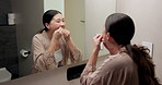 Mirror, home and asian woman with dental floss for oral hygiene or gum care in bathroom. Female person, string or morning routine with reflection or cavity for bacteria or germ removal in house