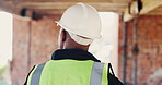 Walking, back and person on construction site for planning, infrastructure and property inspection. Architecture, civil engineering and worker for building safety, renovation and remodeling project