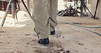 Walking, feet and person on construction site for planning, infrastructure and property inspection. Architecture, civil engineering and legs of worker for building, renovation and remodeling project