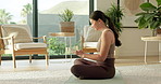 Woman, phone and texting on yoga mat in home for fitness with profile, smile or rest for wellness. Asian person, typing and notification with mobile app, social media or break for exercise at house