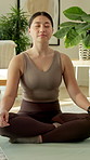 Lotus, meditation and Asian woman in home for yoga, mindfulness and zen for spiritual healing. Female person, eyes closed and breathe at house for yogi, inner peace and holistic balance for self care