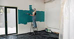 Woman, roller and painting with ladder for home renovation, interior design and property makeover. Back, creative person and art tools in living room with house improvement, diy or remodeling project
