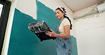 Woman, roller and painting in home with remodeling project, tray and creativity for interior design. Low angle, Asian person and renovation with art equipment for house improvement, diy and makeover.