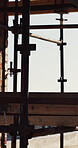 Building, framework and structure with scaffolding on construction site for civil engineering. Metal, support and wood with platform outdoor on worksite for property development or maintenance